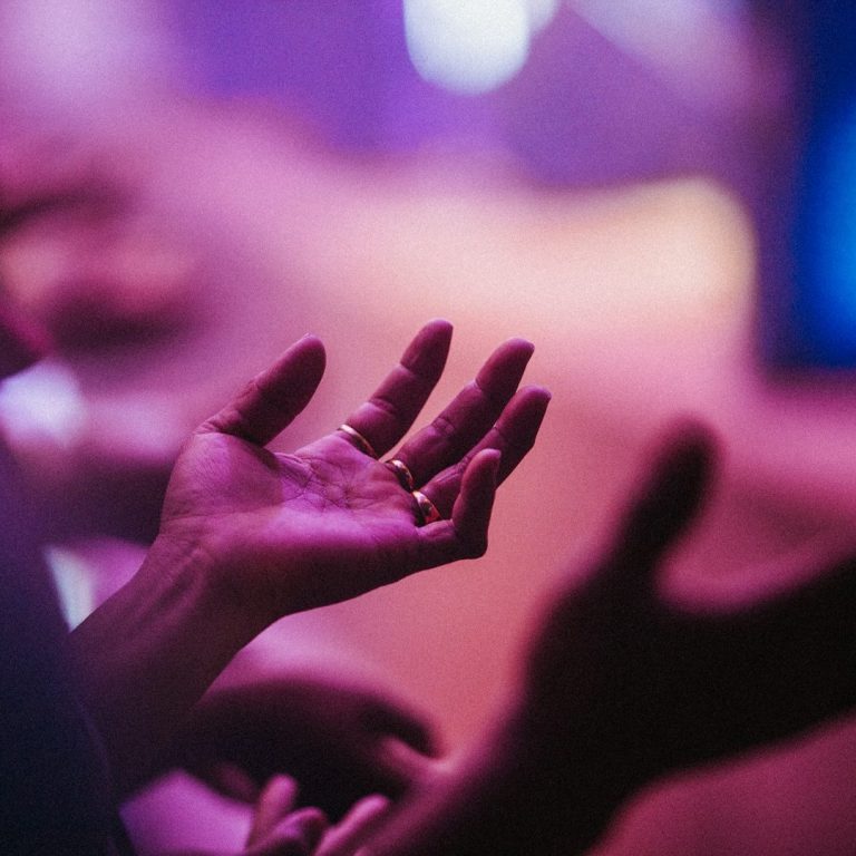 Tongues A photo of someone's hands that are raised in worship